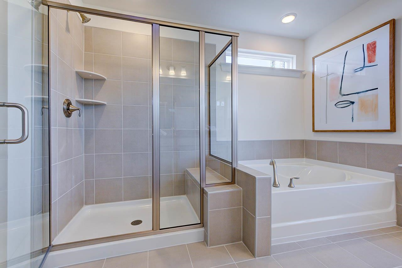 1714 Wimberly Road Apex, NC 27523 - Photo 27 of 45 a bathroom with a bathtub and a shower