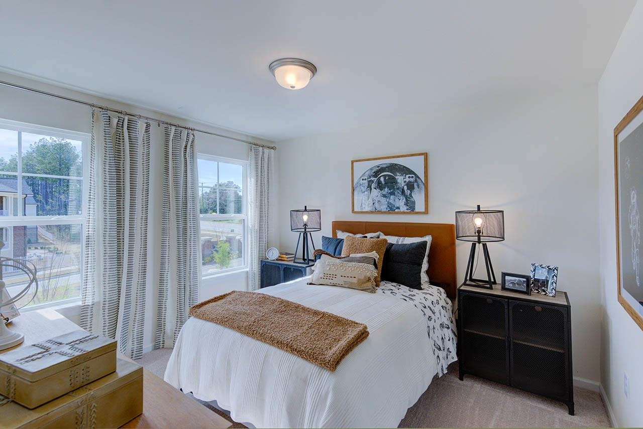 1714 Wimberly Road Apex, NC 27523 - Photo 35 of 45 a bedroom with a bed and wooden floor