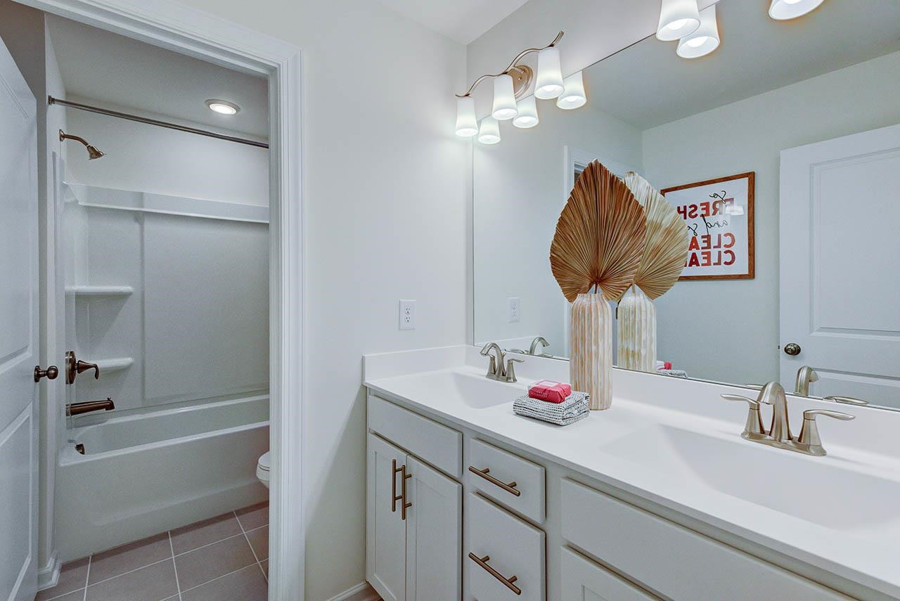 1714 Wimberly Road Apex, NC 27523 - Photo 36 of 45 a bathroom with a sink a shower and a mirror