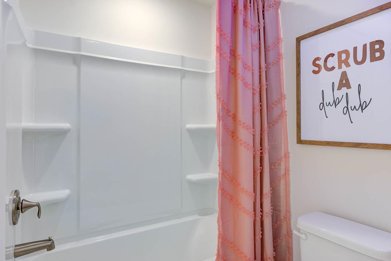 1714 Wimberly Road Apex, NC 27523 - Photo 37 of 45 a bathroom with a bathtub and a shower