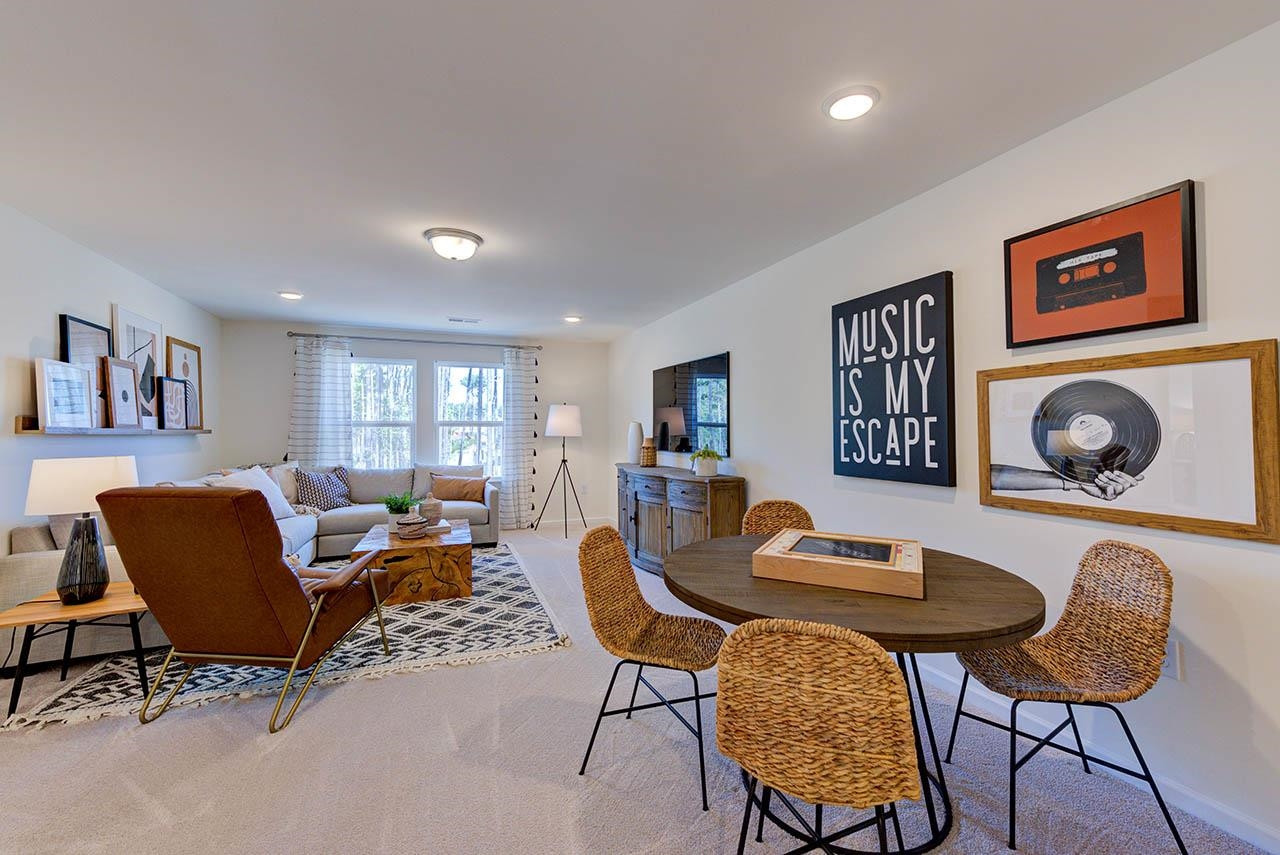 1714 Wimberly Road Apex, NC 27523 - Photo 38 of 45 a living room with furniture and a wooden floor
