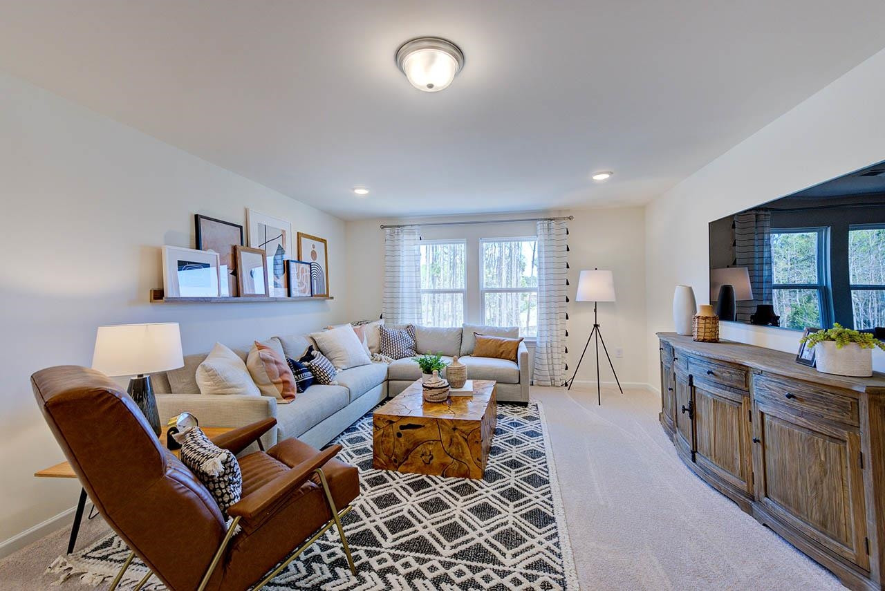 1714 Wimberly Road Apex, NC 27523 - Photo 39 of 45 a living room with furniture and a wooden floor