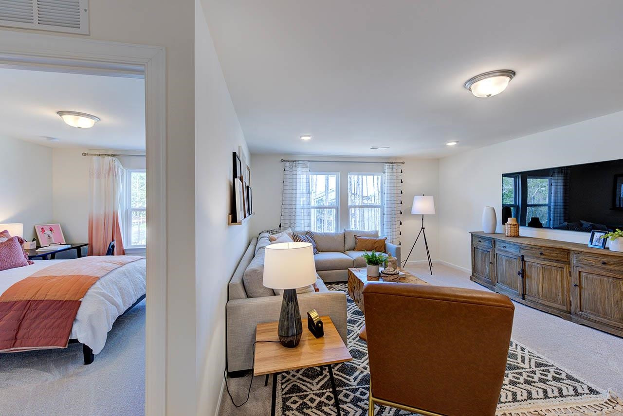 1714 Wimberly Road Apex, NC 27523 - Photo 40 of 45 a living room with furniture and a flat screen tv