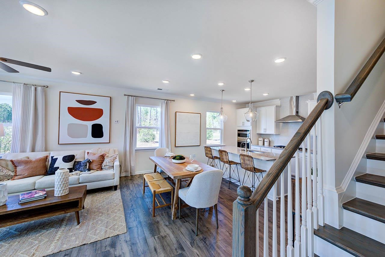 1714 Wimberly Road Apex, NC 27523 - Photo 4 of 45 a living room with furniture and a dining table with wooden floor
