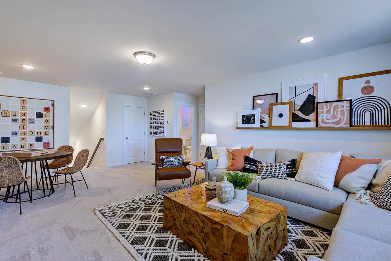 1714 Wimberly Road Apex, NC 27523 - Photo 41 of 45 a living room with furniture a rug and a table