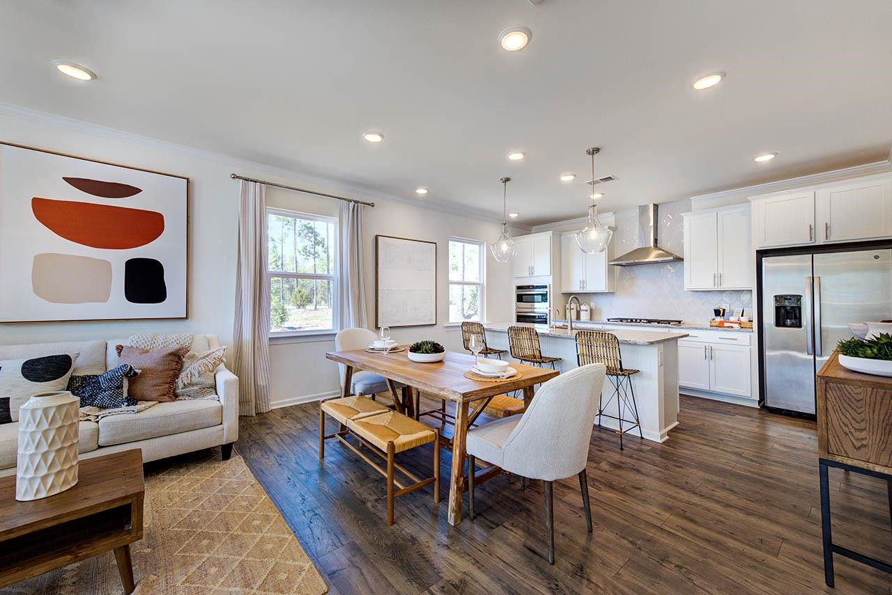 1714 Wimberly Road Apex, NC 27523 - Photo 7 of 45 a view of a dining room with furniture and wooden floor