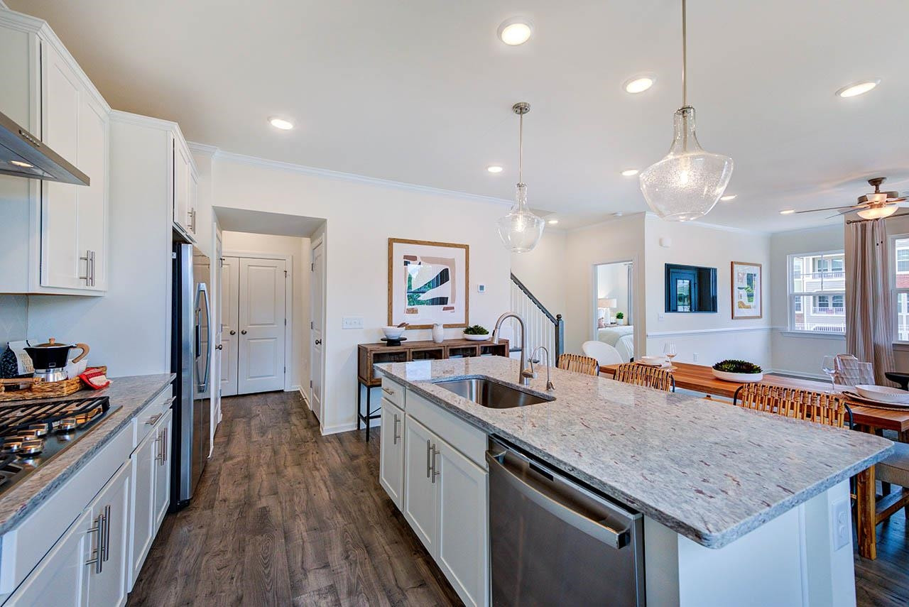 1714 Wimberly Road Apex, NC 27523 - Photo 10 of 45 a kitchen with granite countertop a stove and a sink