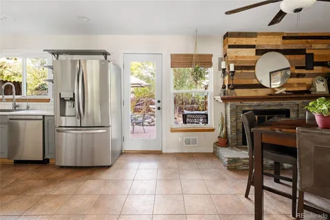 a kitchen with stainless steel appliances granite countertop a stove top oven a sink a counter space and cabinets