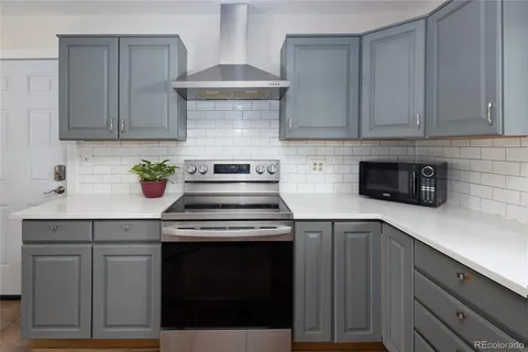 a kitchen with cabinets appliances and a sink