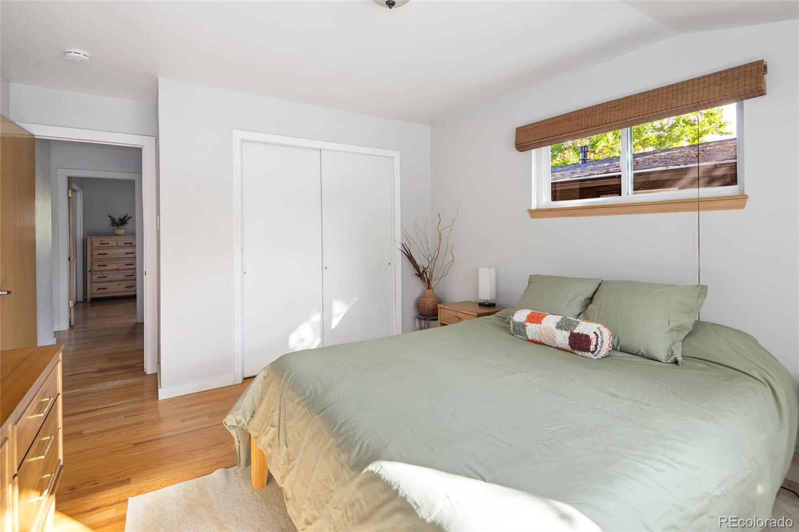 1550 South Forest Street Denver, CO 80222 - Photo 16 of 38 a bedroom with a bed and wooden floor