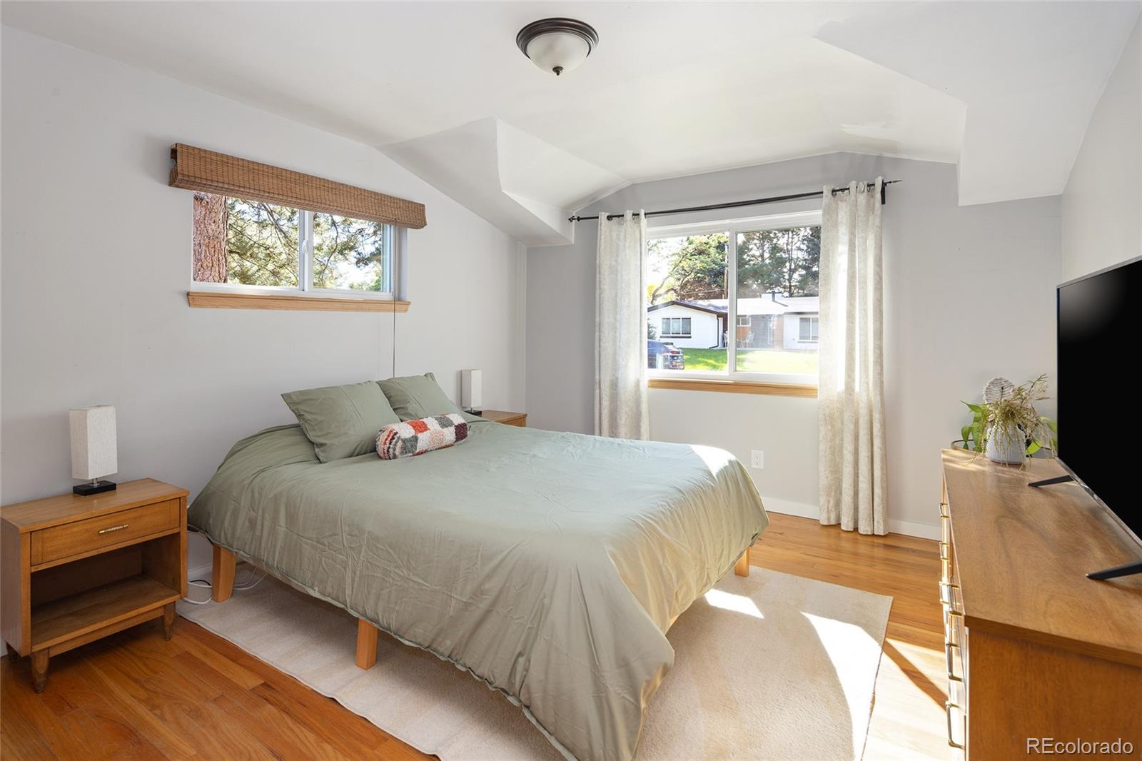 1550 South Forest Street Denver, CO 80222 - Photo 17 of 38 a bedroom with a bed and a flat screen tv