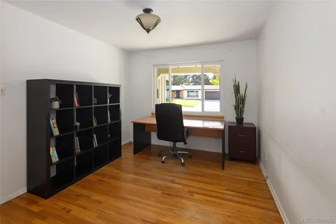 a view of a workspace with furniture and a window