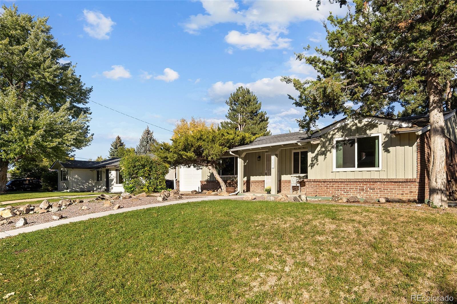 1550 South Forest Street Denver, CO 80222 - Photo 2 of 38 a front view of a house with a yard and trees