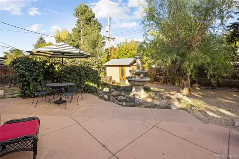 a view of a chairs and table in backyard