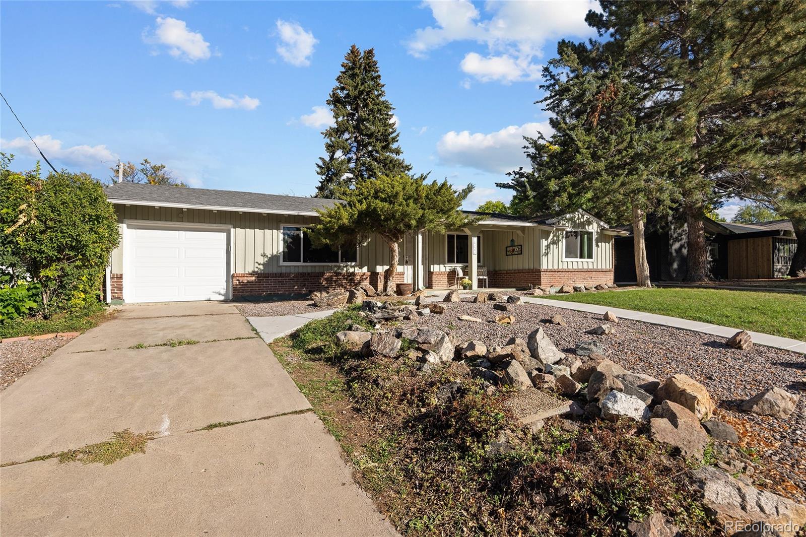 1550 South Forest Street Denver, CO 80222 - Photo 3 of 38 a front view of a house with a yard and potted plants