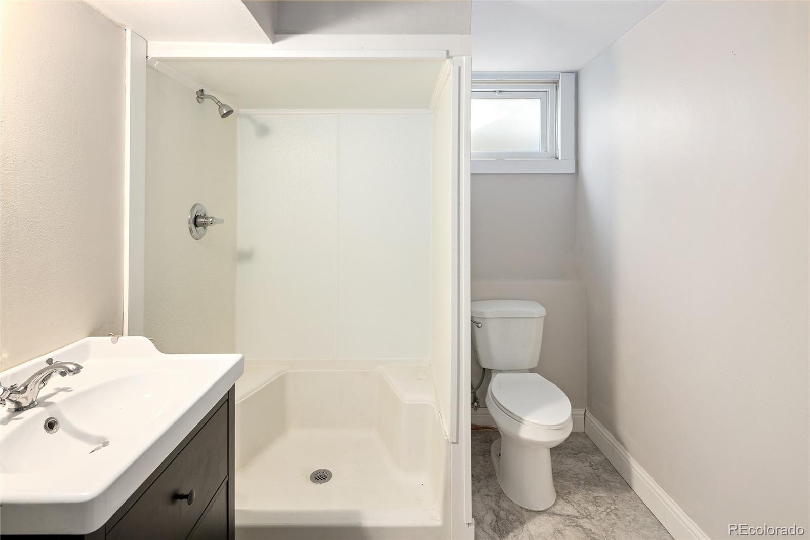 1550 South Forest Street Denver, CO 80222 - Photo 33 of 38 a bathroom with a sink a toilet and shower