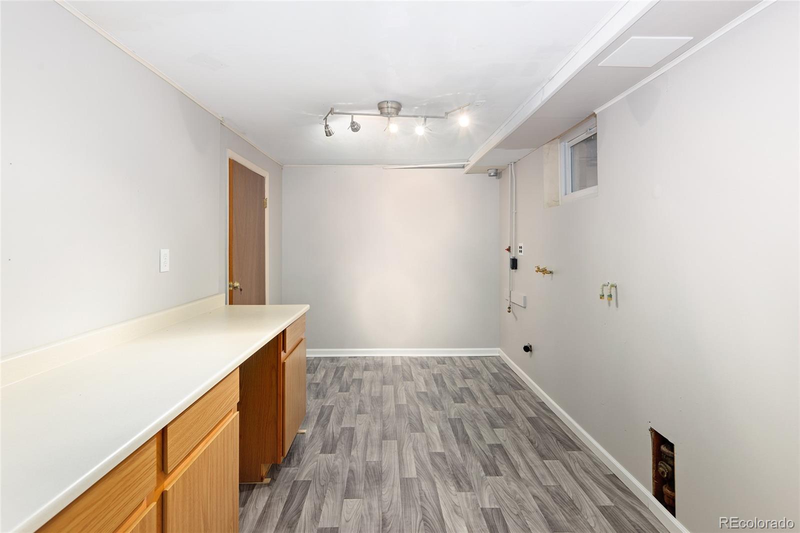 1550 South Forest Street Denver, CO 80222 - Photo 34 of 38 a room with wooden floor and window