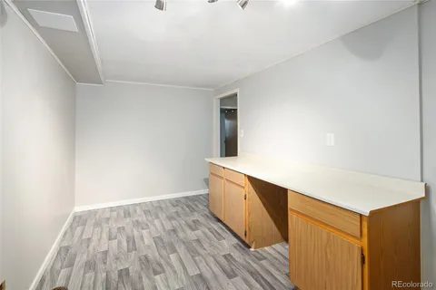 a room with wooden floor and fan