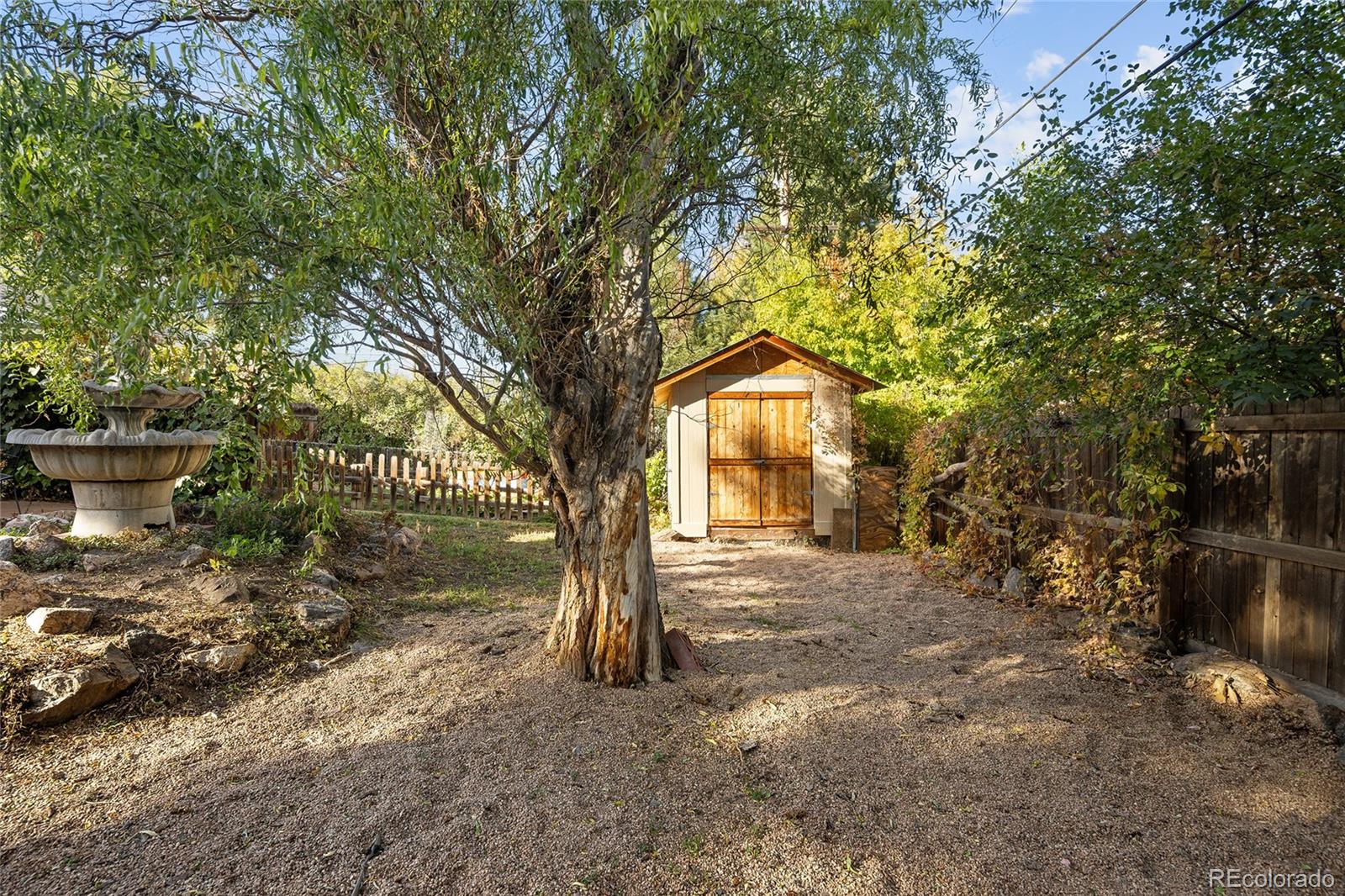 1550 South Forest Street Denver, CO 80222 - Photo 37 of 38 a front view of a house with a yard and trees