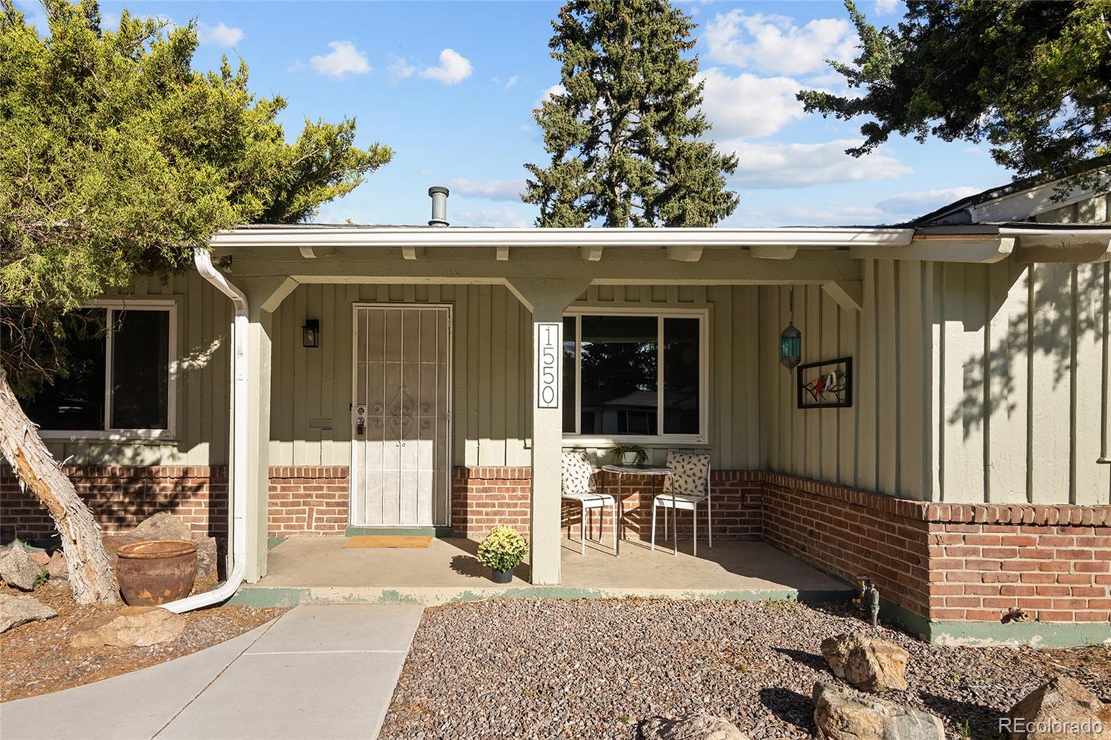1550 South Forest Street Denver, CO 80222 - Photo 4 of 38 a view of a patio with table and chairs and potted plants