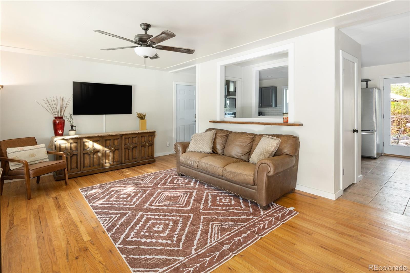 1550 South Forest Street Denver, CO 80222 - Photo 5 of 38 a living room with furniture and a flat screen tv