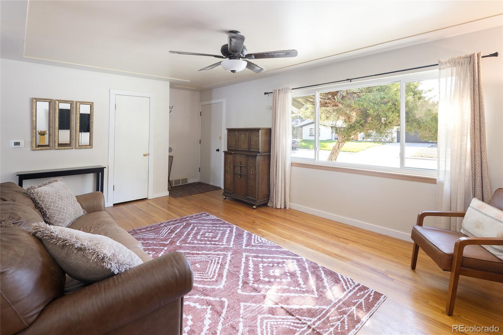 1550 South Forest Street Denver, CO 80222 - Photo 6 of 38 a bedroom with a bed and wooden floor