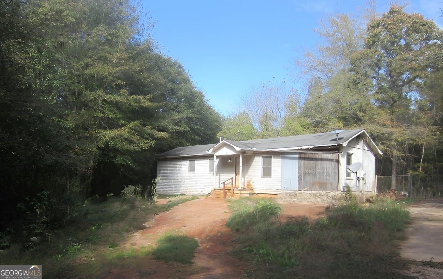 333 Yamacraw Road Griffin, GA 30223 - Photo 1 of 1 a view of a white house next to a yard with a large tree