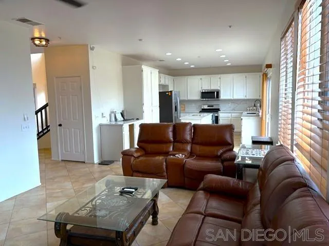 8873 Gumtree Lane Riverside, CA 92508 - Photo 8 of 36 a living room with furniture and a large window