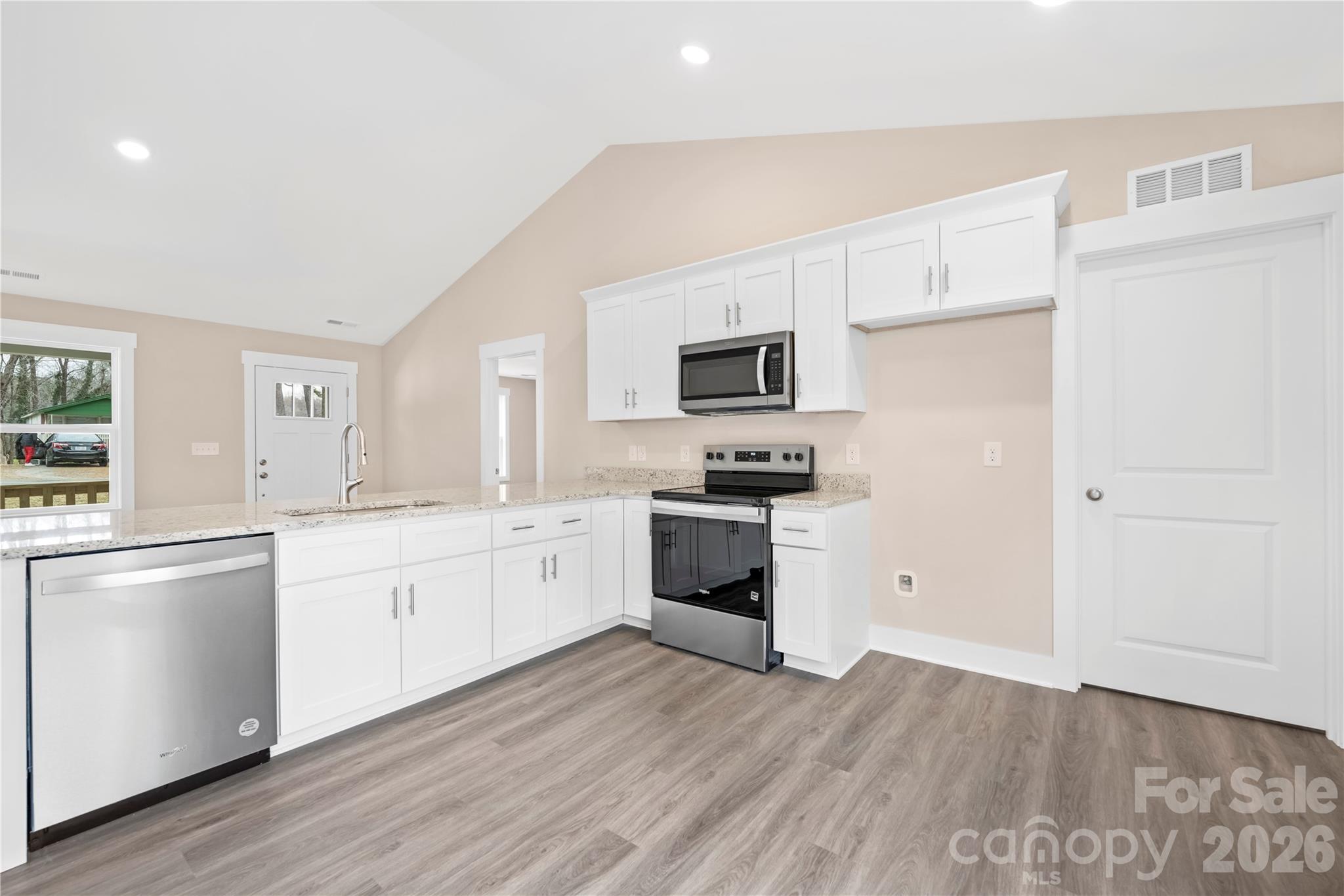 407 Queens Road Gastonia, NC 28052 - Photo 12 of 34 a kitchen with granite countertop white cabinets and stainless steel appliances
