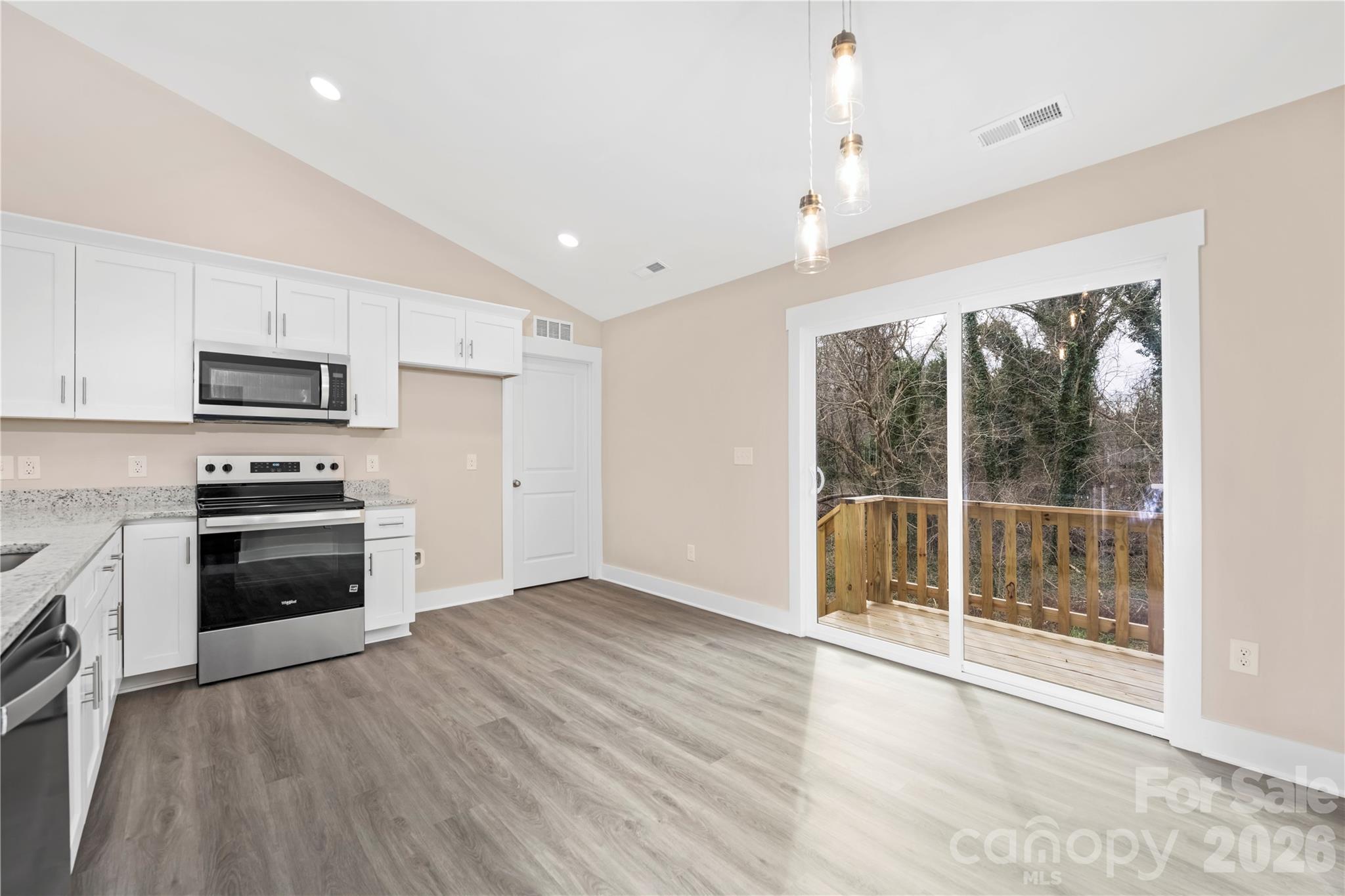 407 Queens Road Gastonia, NC 28052 - Photo 14 of 34 a kitchen with granite countertop a stove a sink and a refrigerator
