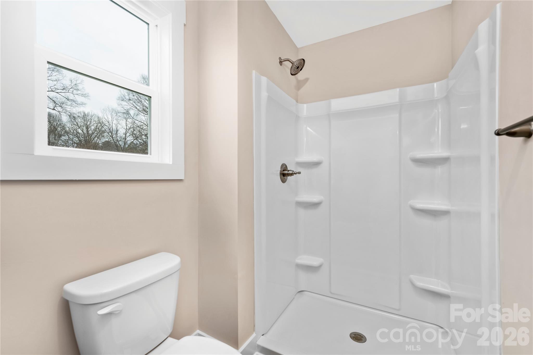407 Queens Road Gastonia, NC 28052 - Photo 19 of 34 a bathroom with a toilet and shower