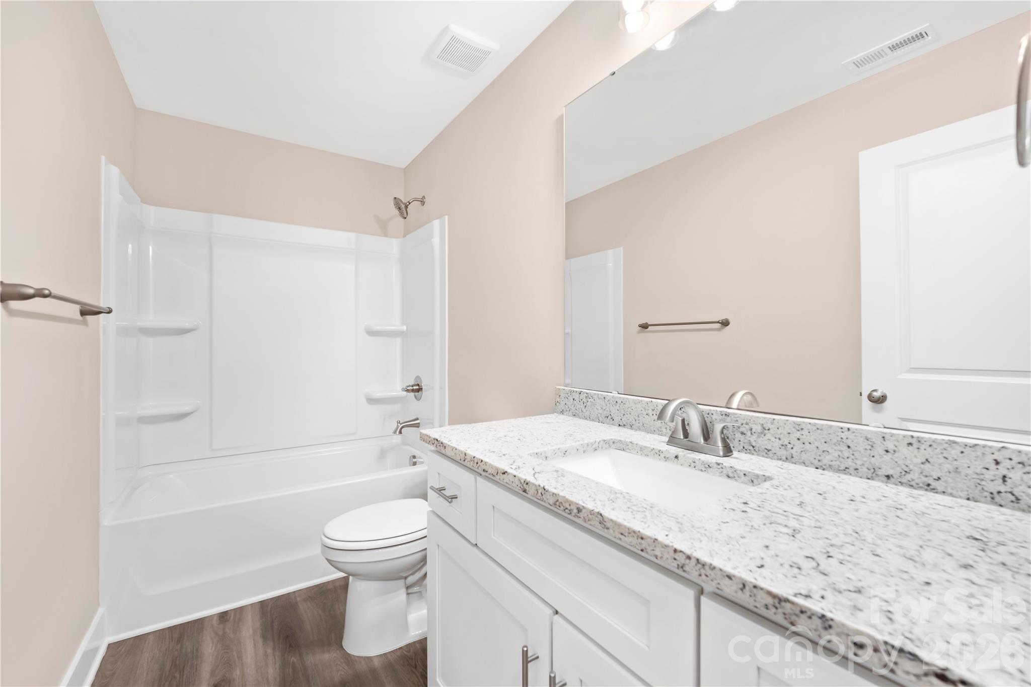 407 Queens Road Gastonia, NC 28052 - Photo 26 of 34 a bathroom with a granite countertop sink a toilet and bathtub