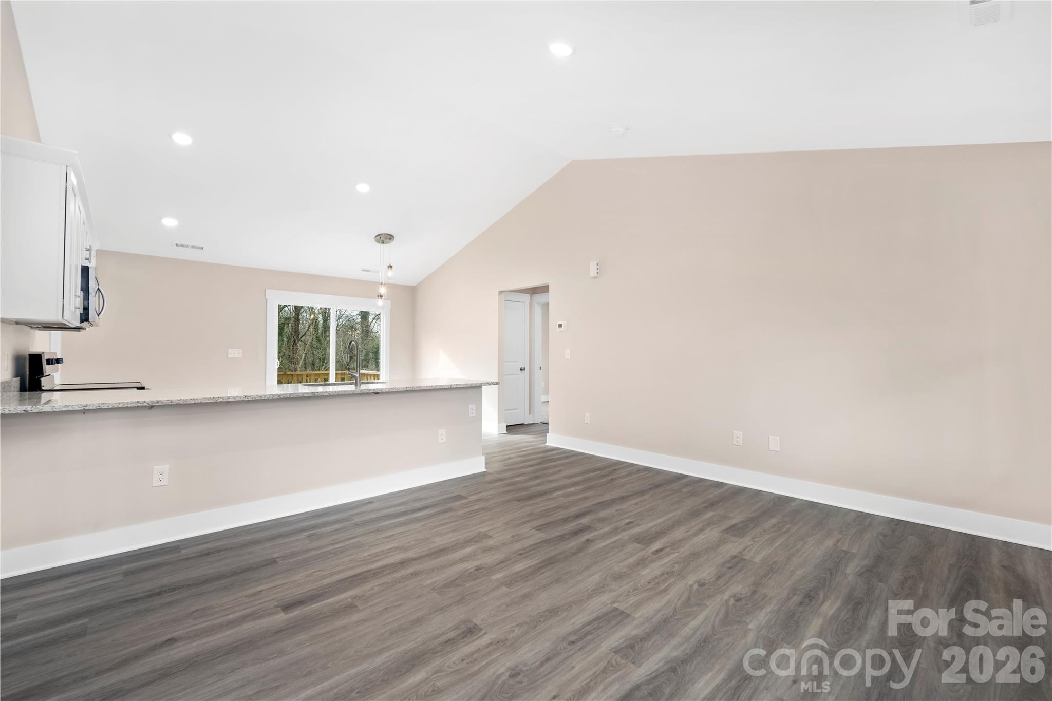 407 Queens Road Gastonia, NC 28052 - Photo 9 of 34 a view of an empty room with wooden floor and a window