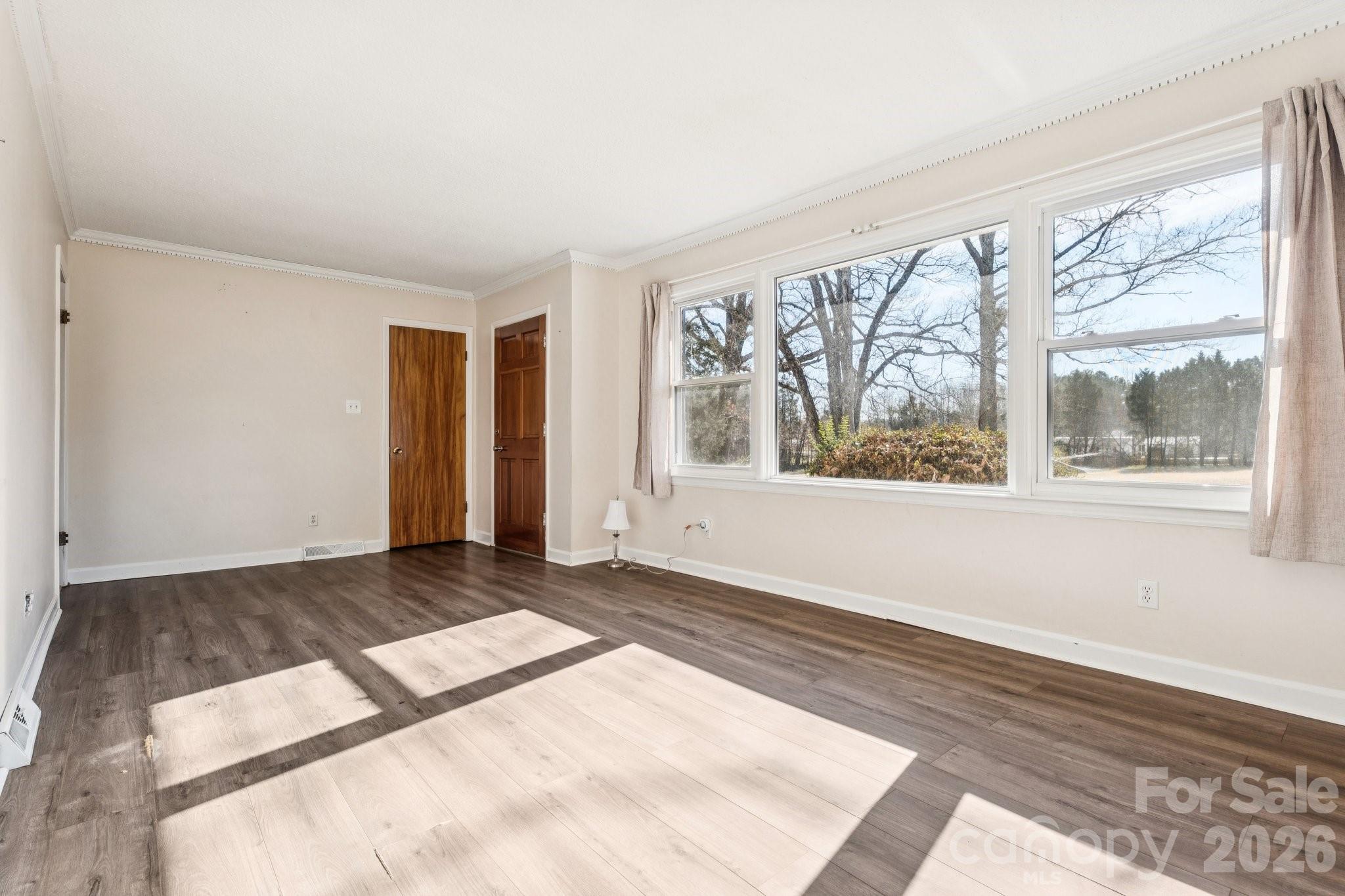 9525 Brief Road Charlotte, NC 28227 - Photo 12 of 46 a view of an empty room with wooden floor and a window