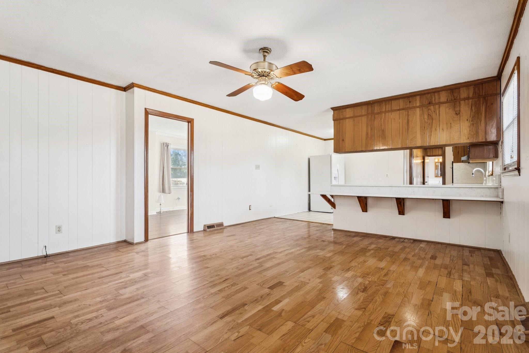 9525 Brief Road Charlotte, NC 28227 - Photo 16 of 46 a view of a kitchen with wooden floor and a ceiling fan