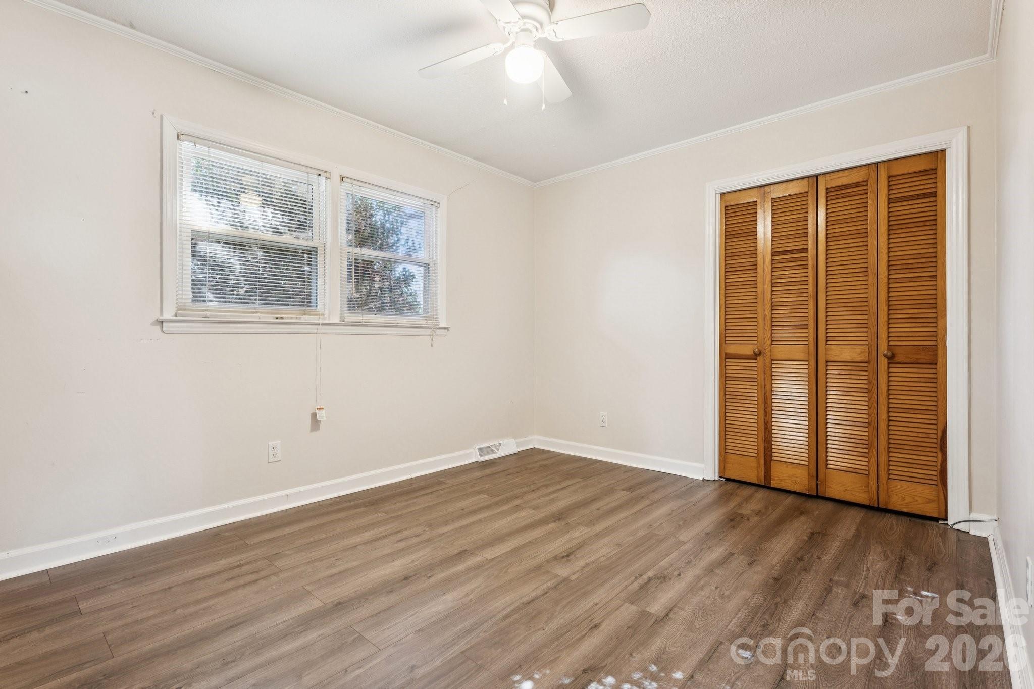 9525 Brief Road Charlotte, NC 28227 - Photo 23 of 46 an empty room with wooden floor and windows