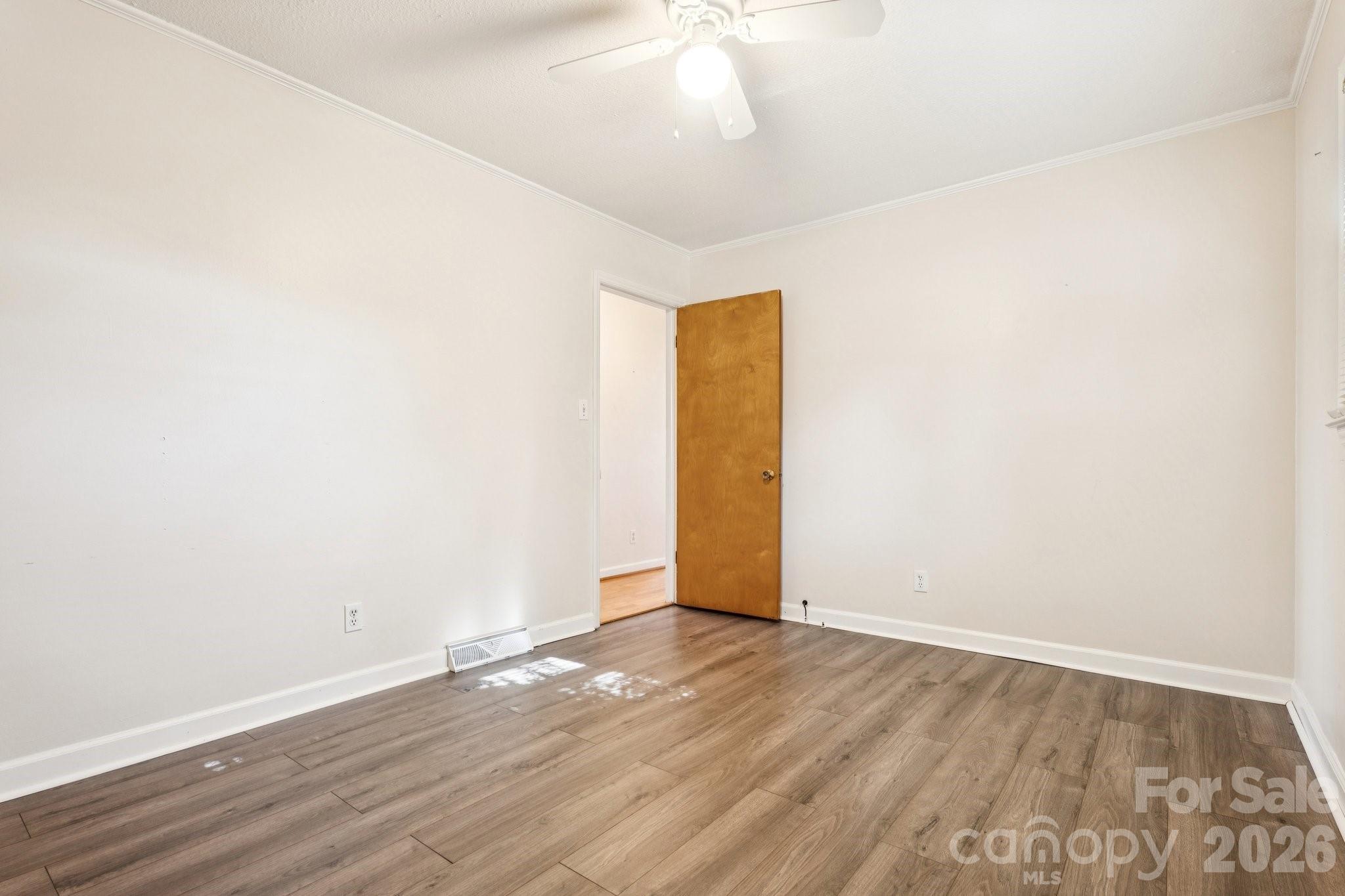 9525 Brief Road Charlotte, NC 28227 - Photo 24 of 46 an empty room with wooden floor and natural light