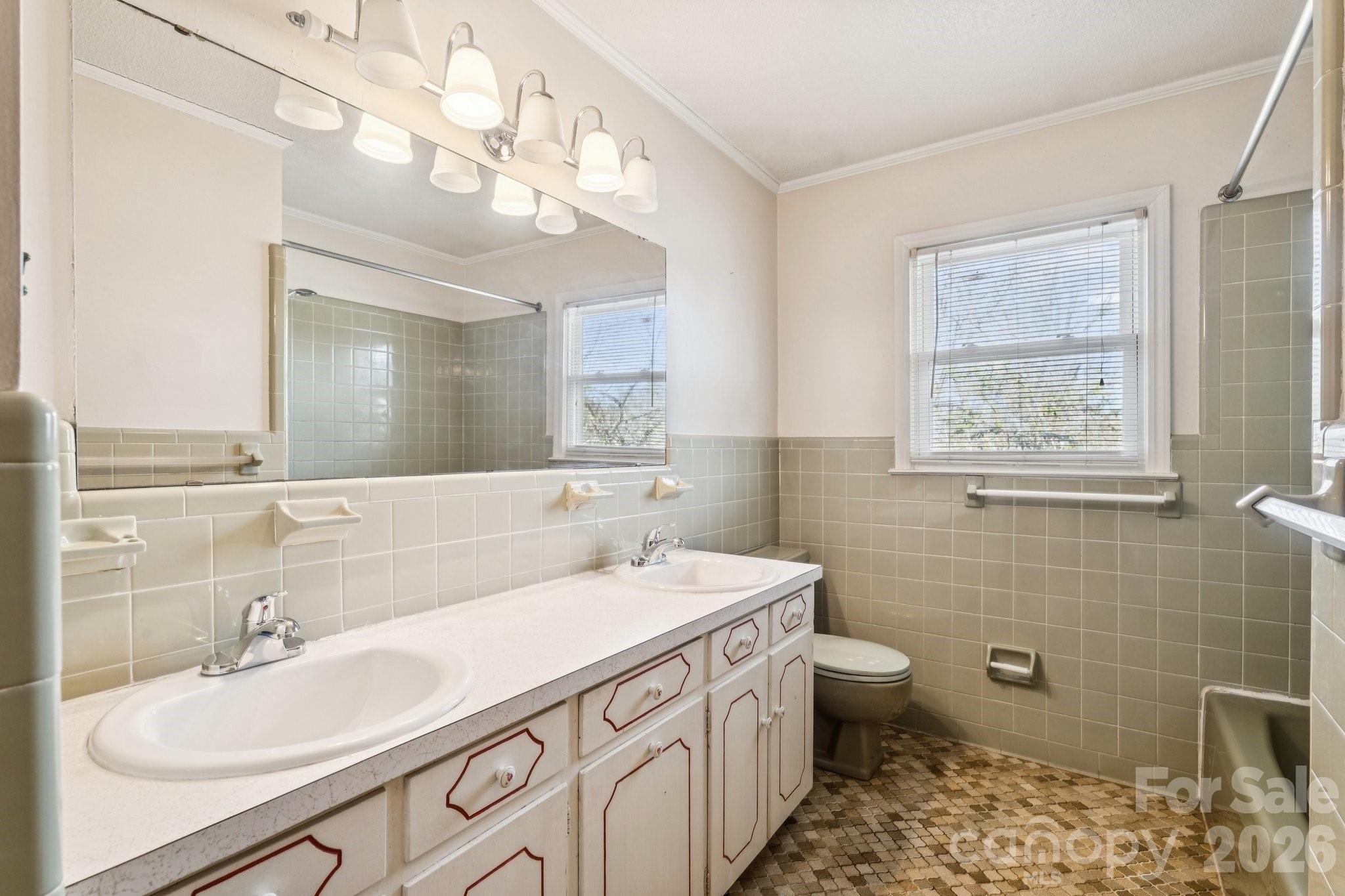 9525 Brief Road Charlotte, NC 28227 - Photo 25 of 46 a bathroom with a sink a toilet a mirror and shower