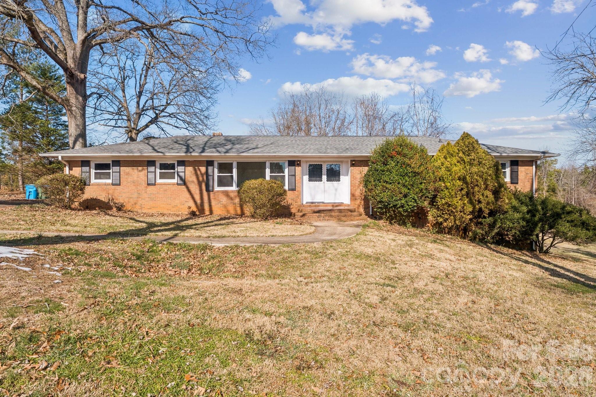 9525 Brief Road Charlotte, NC 28227 - Photo 39 of 46 a front view of house with yard and trees around