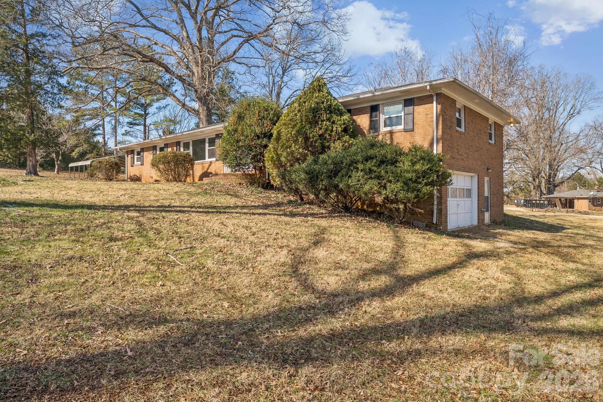 9525 Brief Road Charlotte, NC 28227 - Photo 40 of 46 a front view of a house with a yard covered with snow