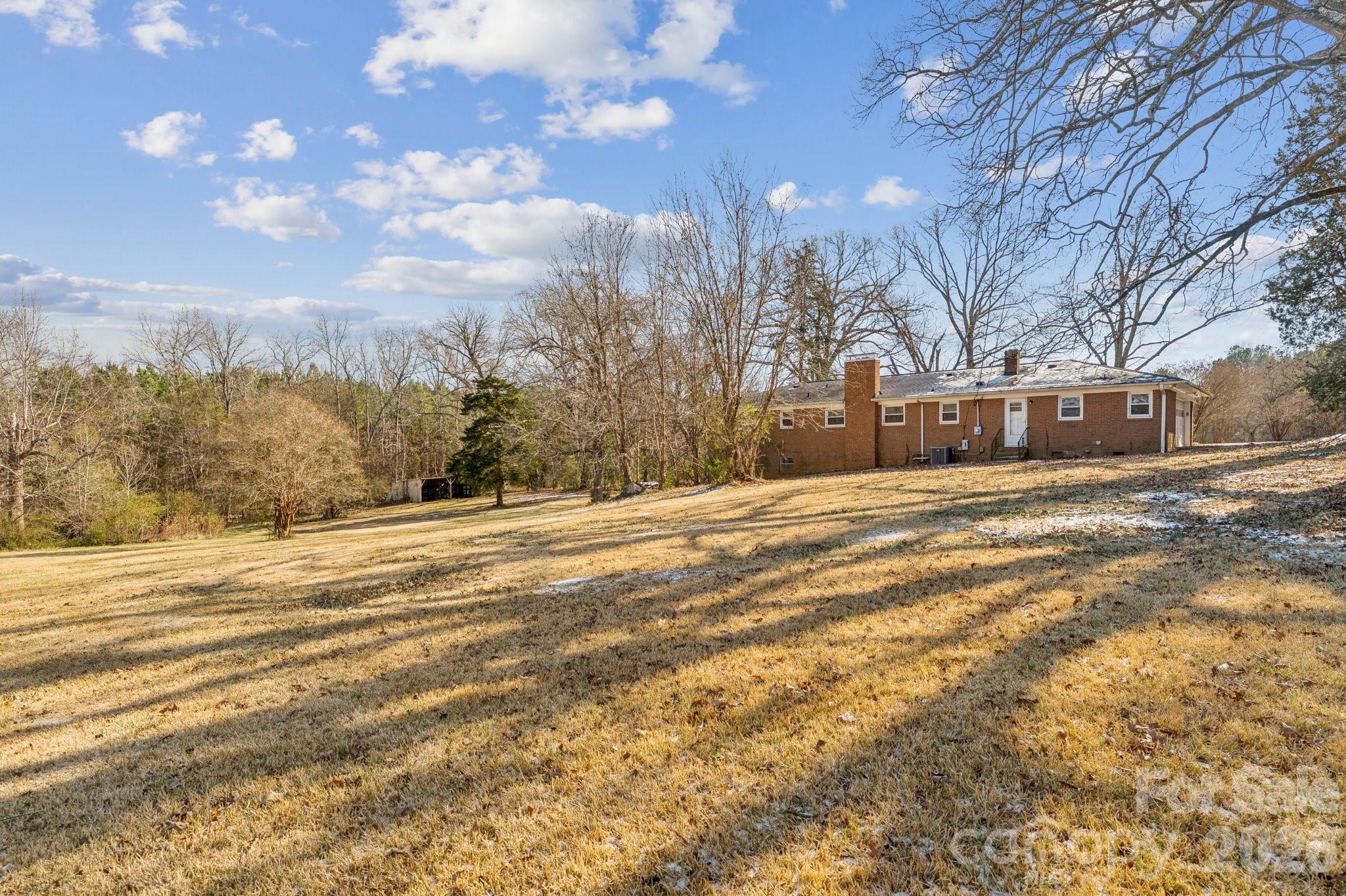 9525 Brief Road Charlotte, NC 28227 - Photo 42 of 46 a view of large trees and mountains in the background