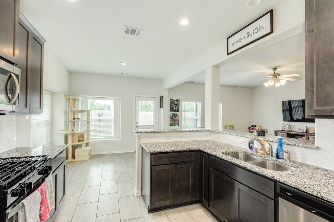 177 Bayou Bend Boulevard Angleton, TX 77515 - Photo 17 of 33 a kitchen with a sink stove and cabinets