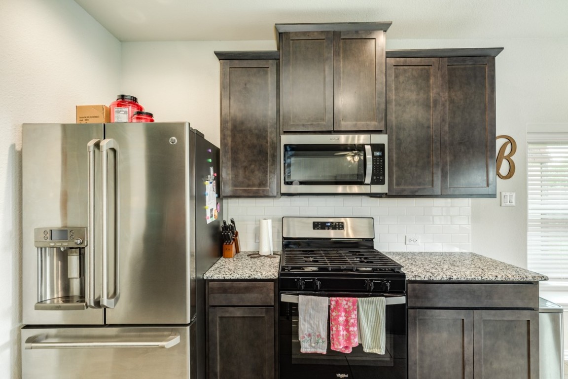 177 Bayou Bend Boulevard Angleton, TX 77515 - Photo 18 of 33 a kitchen with stainless steel appliances granite countertop a refrigerator and a stove top oven