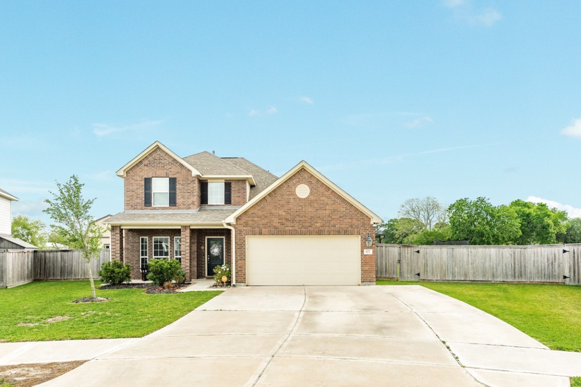 177 Bayou Bend Boulevard Angleton, TX 77515 - Photo 2 of 33 a front view of a house with a yard and garage