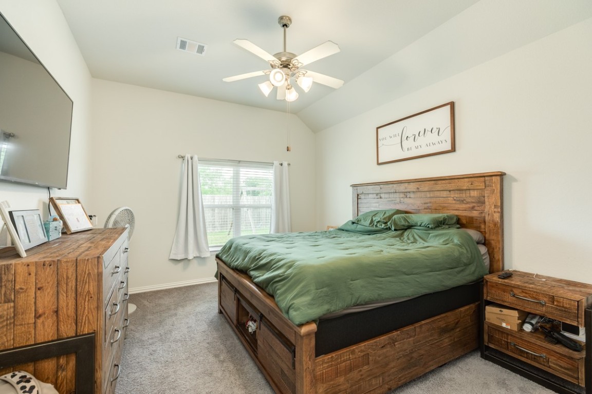177 Bayou Bend Boulevard Angleton, TX 77515 - Photo 23 of 33 a bedroom with a bed and a chandelier