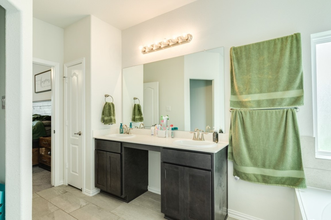 177 Bayou Bend Boulevard Angleton, TX 77515 - Photo 24 of 33 a bathroom with a sink and a mirror