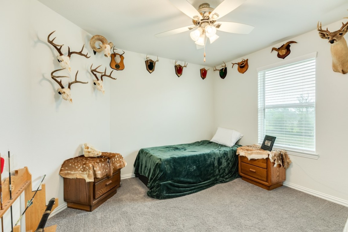 177 Bayou Bend Boulevard Angleton, TX 77515 - Photo 28 of 33 a room with a bed and a chandelier