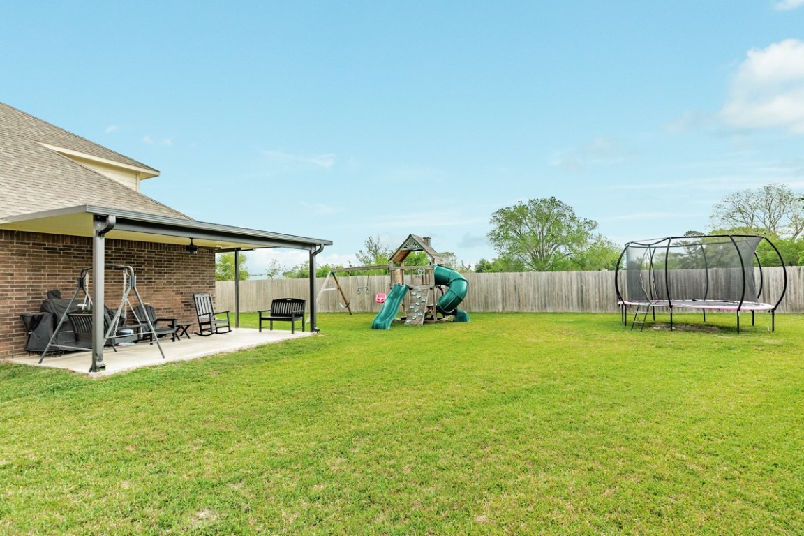 177 Bayou Bend Boulevard Angleton, TX 77515 - Photo 6 of 33 a view of a chair and table in backyard of the house