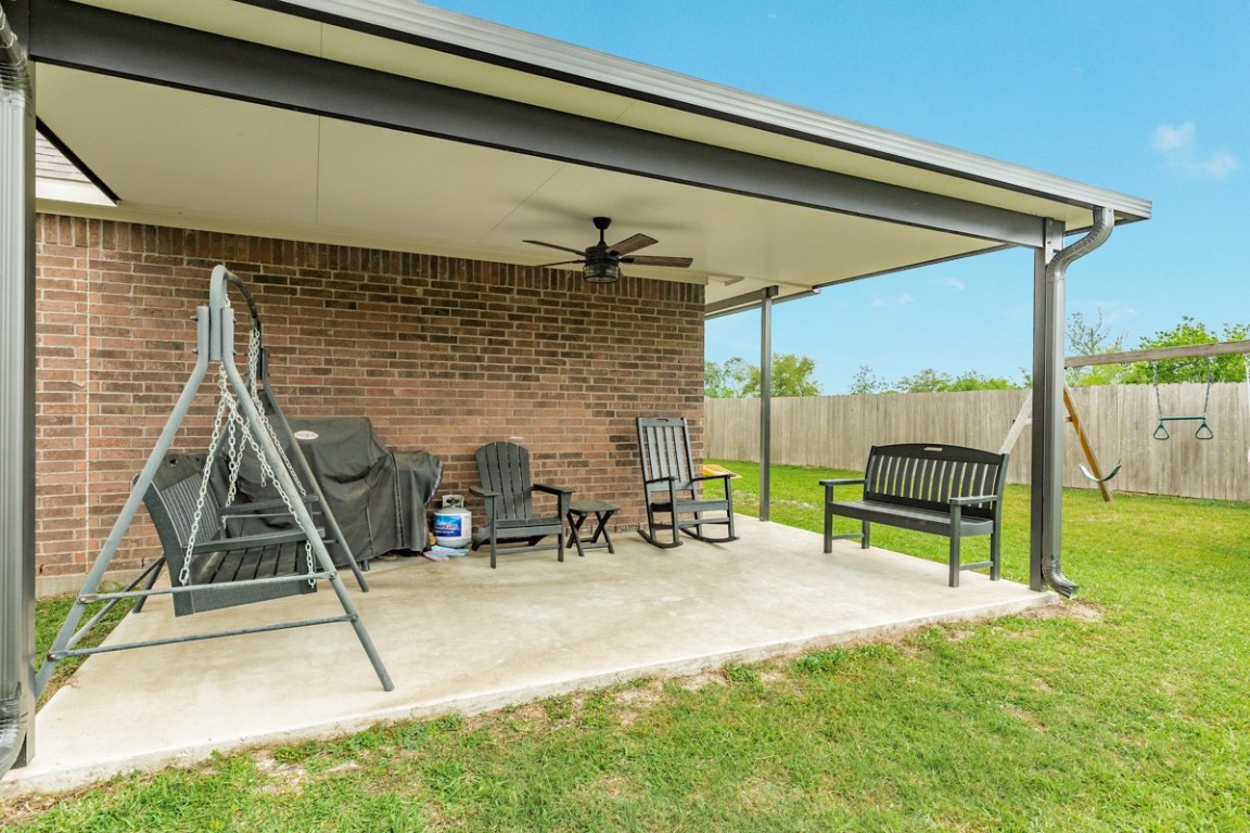 177 Bayou Bend Boulevard Angleton, TX 77515 - Photo 8 of 33 a view of a patio with a table chairs and a wooden fence