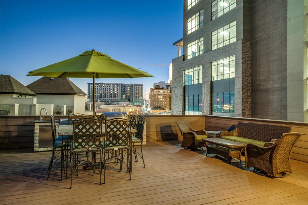 a patio with sofas table and chairs